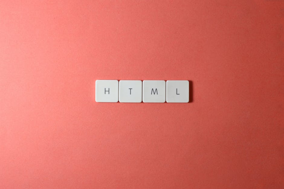 Four white keyboard keycaps arranged horizontally on a pink background, each labeled with a black letter spelling 'HTML', representing surface cleaning or organisation of digital elements, with no vis